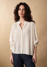 Fine detail textured high neck blouse with ruffle neck