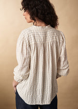 Fine detail textured high neck blouse with ruffle neck