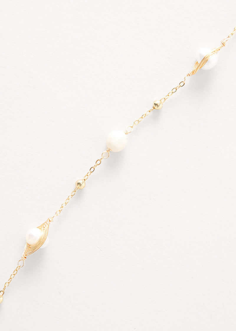 Pearl on gold chain necklace with tassel detail