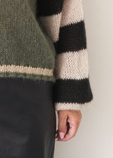 Khaki sweater with black and white stripe sleeves