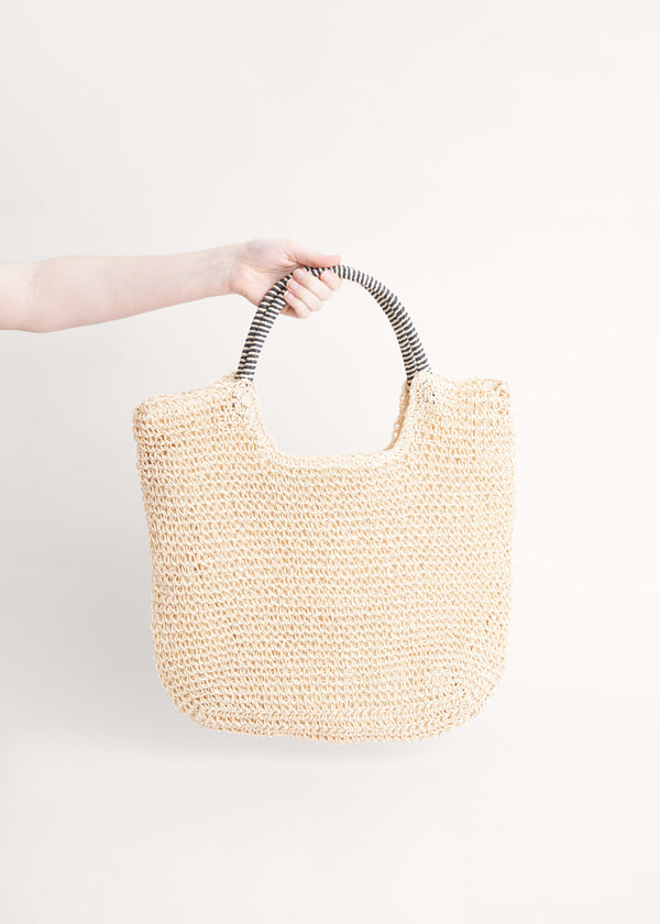 A cream tote shopper bag made from crochet raffia