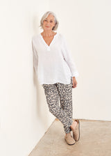 Light oatmeal leopard print trousers and White oversized linen top